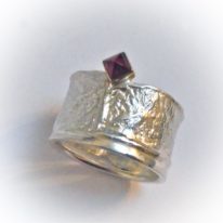 Wide Reticulated Ring with Garnet by Andrea Russell at The Avenue Gallery, a contemporary fine art gallery in Victoria, British Columbia, Canada.