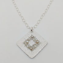 Textured Diamond-Shape Pendant with Crocheted Wire, Pearls & Swarovski Crystals by Veronica Stewart at The Avenue Gallery, a contemporary fine art gallery in Victoria, BC, Canada.