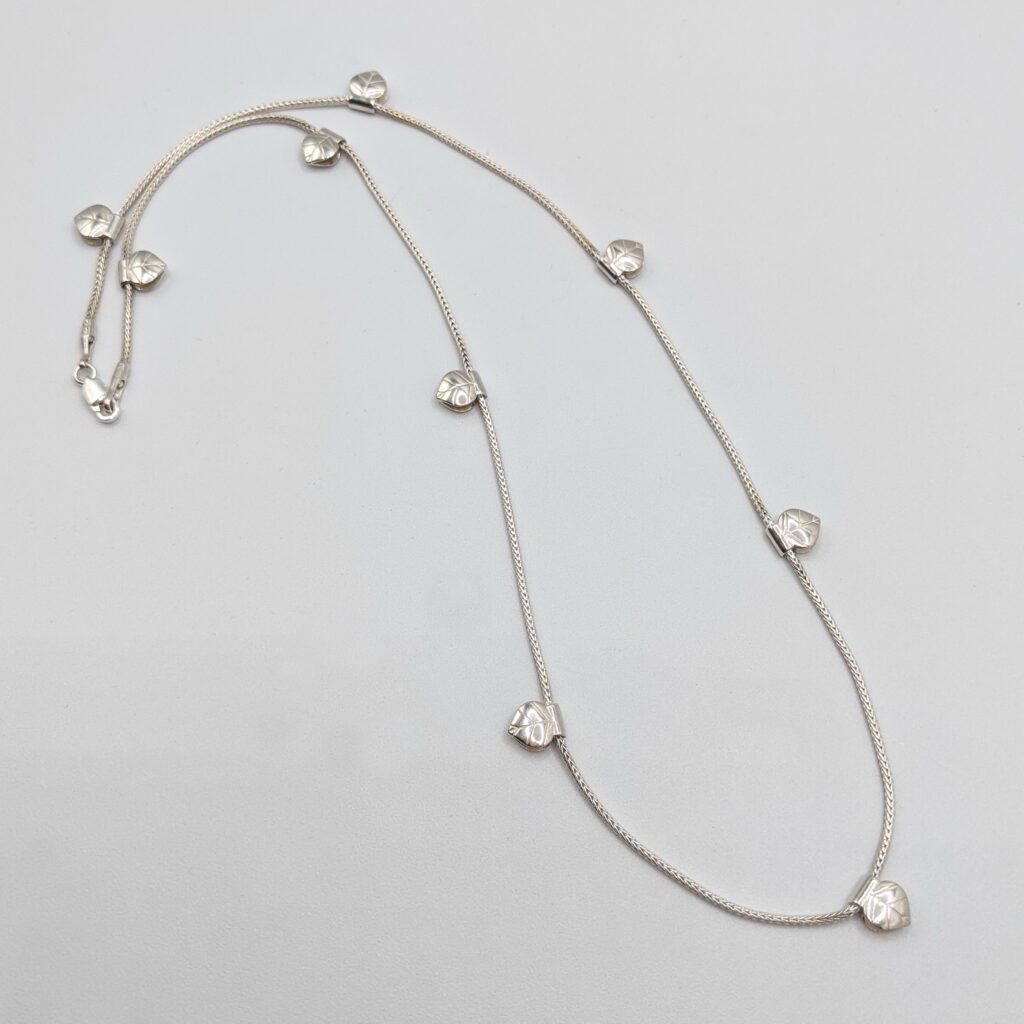 Camellia Necklace by MichaudMichaud Design at The Avenue Gallery, a contemporary fine art gallery in Victoria, BC, Canada.