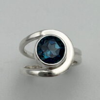 Buttonhole Band Ring with London Topaz by A & R Jewellery at The Avenue Gallery, a contemporary fine art gallery in Victoria, BC, Canada.