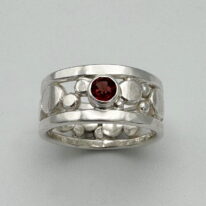 Flat Granules Ring with Garnet by A & R Jewellery at The Avenue Gallery, a contemporary fine art gallery in Victoria, BC, Canada.