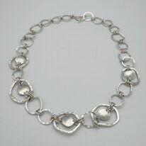 Free Form Circle Argentium Silver Necklace with Sun Accents by A & R Jewellery at The Avenue Gallery, a contemporary fine art gallery in Victoria, BC, Canada.