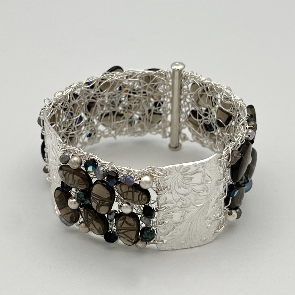 Crocheted Fine Silver Wire Cuff with Textured Bars and Smoky Quartz, Swarovski Crystals and Pearls by Veronica Stewart at The Avenue Gallery, a contemporary fine art gallery in Victoria, BC, Canada.
