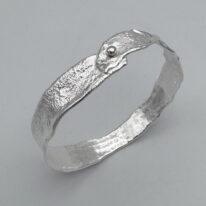 Narrow Reticulated Bangle with Gold Ball by Barbara Adams at The Avenue Gallery, a contemporary fine art gallery in Victoria, BC, Canada.