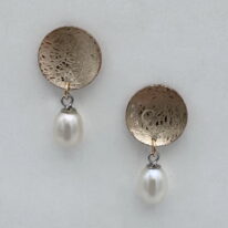 Balanced Scribbled Concaved Gold-Filled Disc Earrings with White Pearls by Chi’s Creations at The Avenue Gallery, a contemporary fine art gallery in Victoria, BC, Canada.