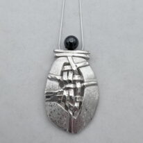 Woven Shield Necklace with Hematite by Chi’s Creations at The Avenue Gallery, a contemporary fine art gallery in Victoria, BC, Canada.