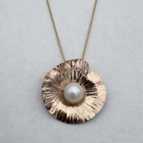 Hammered Gold-Filled Lily Pad Necklace with White Pearl by Chi’s Creations at The Avenue Gallery, a contemporary fine art gallery in Victoria, BC, Canada.
