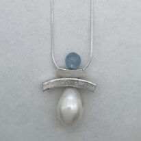 Balanced Inukshuk Necklace with Aquamarine and Pearl by Chi’s Creations at The Avenue Gallery, a contemporary fine art gallery in Victoria, BC, Canada.