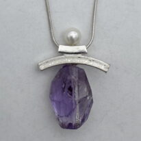 Balanced Inukshuk Necklace with Pearl and Amethyst Crystal by Chi’s Creations at The Avenue Gallery, a contemporary fine art gallery in Victoria, BC, Canada.