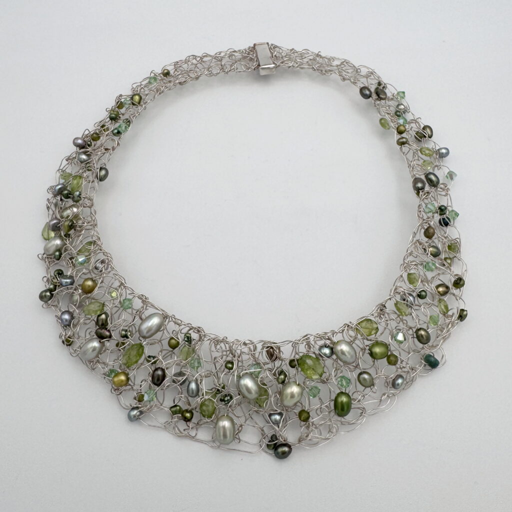 Fine Silver Knitted Collar with Green Freshwater Pearls, Peridot & Swarovski Crystals by Veronica Stewart at The Avenue Gallery, a contemporary fine art gallery in Victoria, BC, Canada.